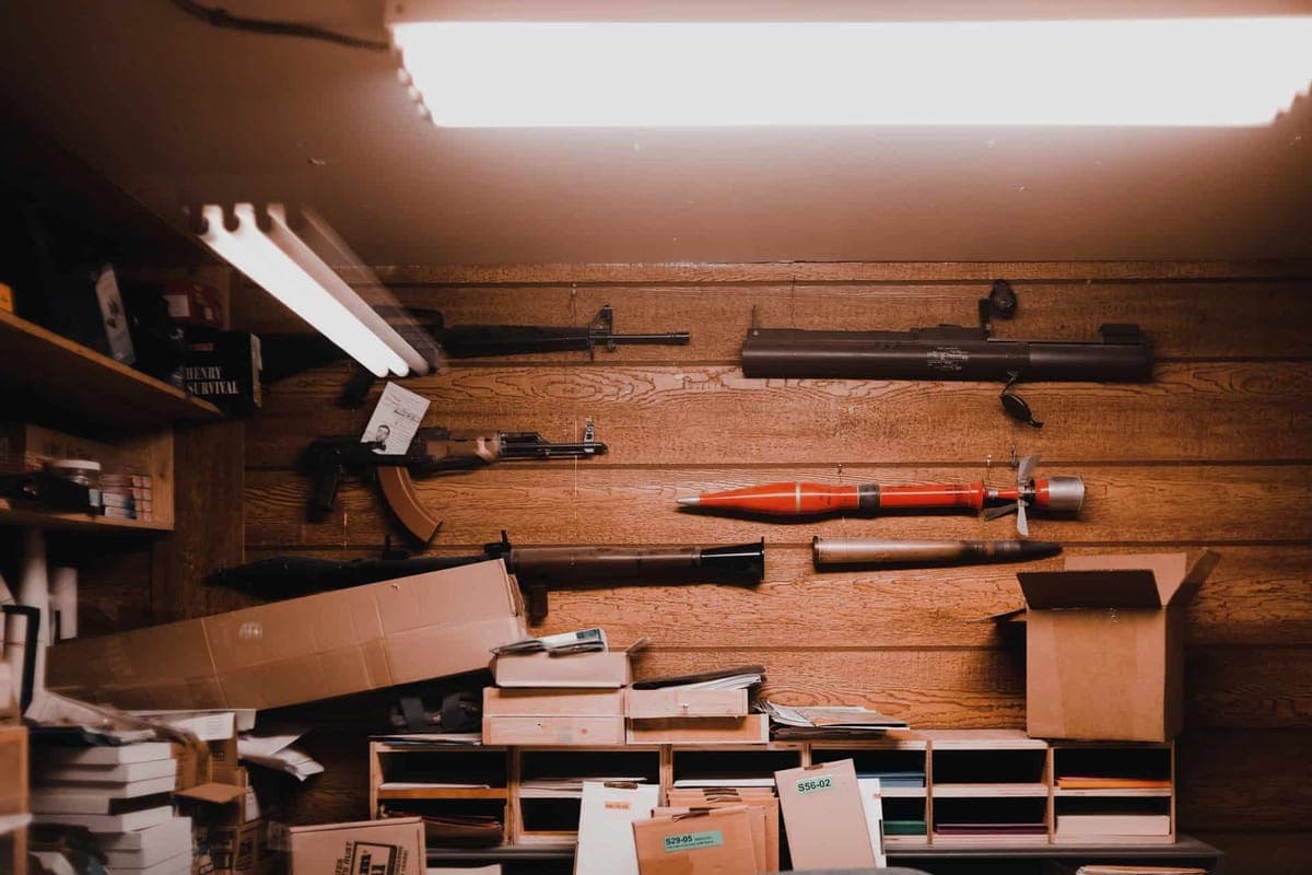 Storage containers held in a ceiling-mounted rail system in a garage