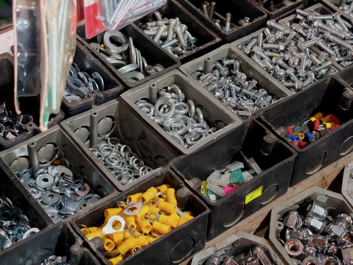 Sorted screws, washers and connectors in open compartment bins