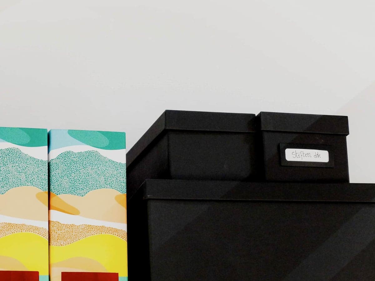 Labeled storage boxes arranged neatly on a shelf