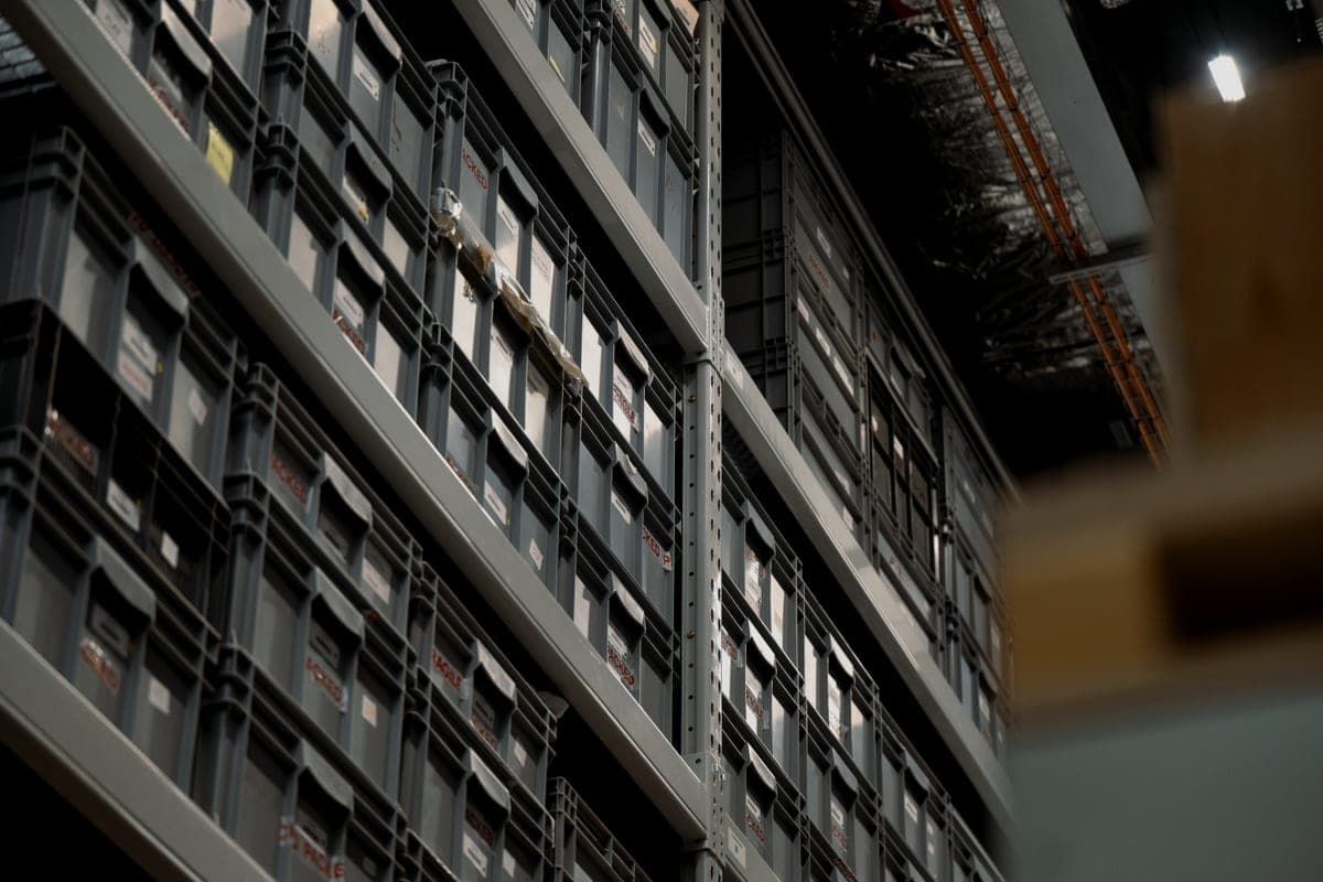 Industrial shelving racks filled with stacked plastic storage boxes