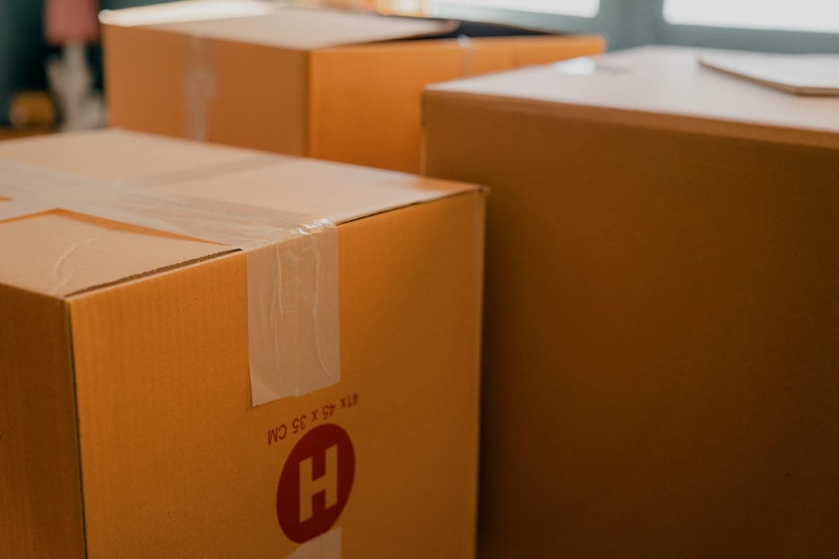 Sealed cardboard moving boxes stacked in a room