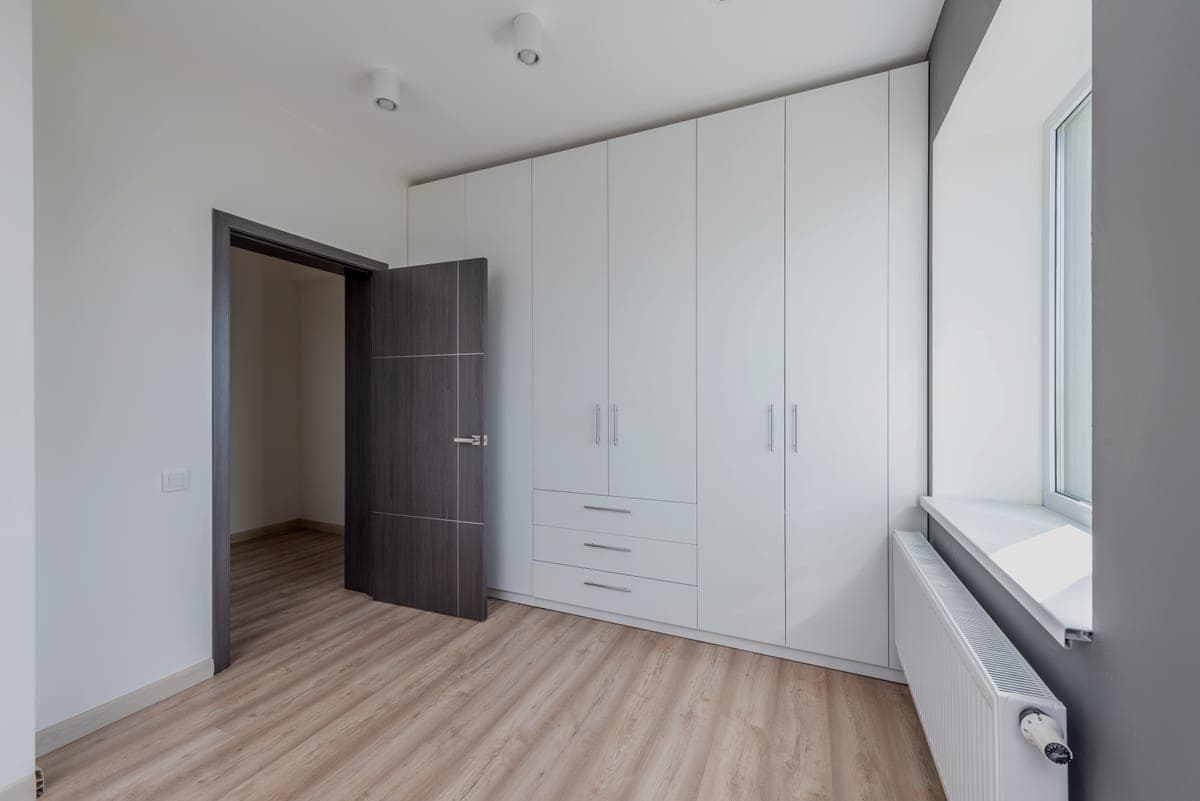 White storage cabinets with closed doors along a wall