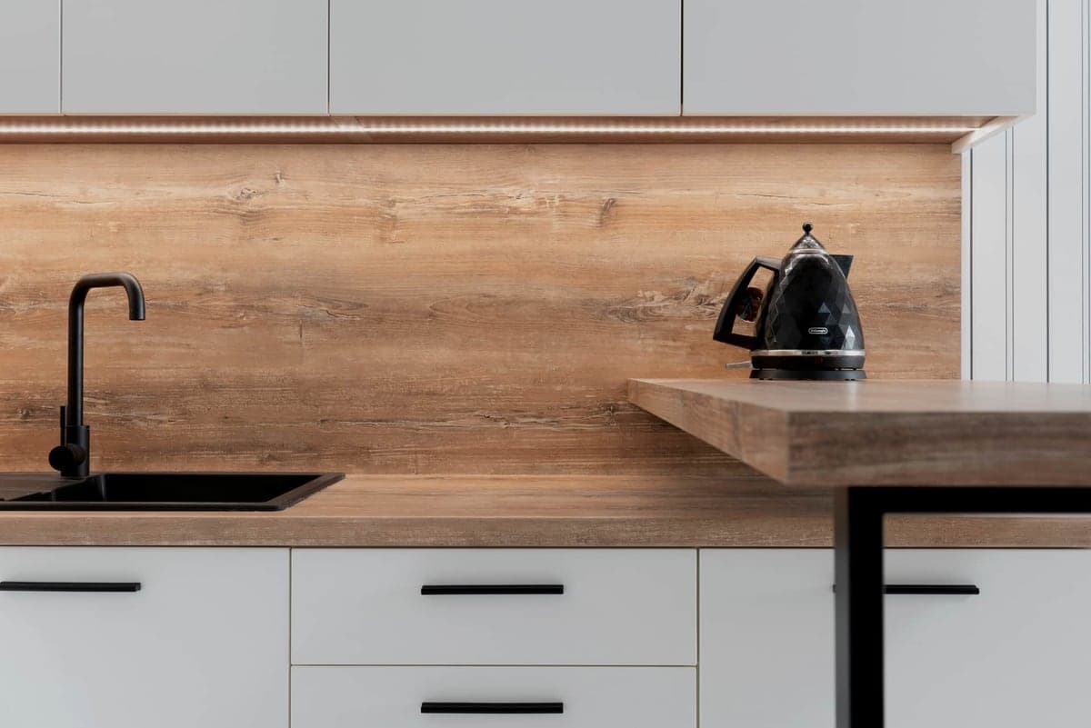 A modular garage cabinet and wall storage system installed along a wall