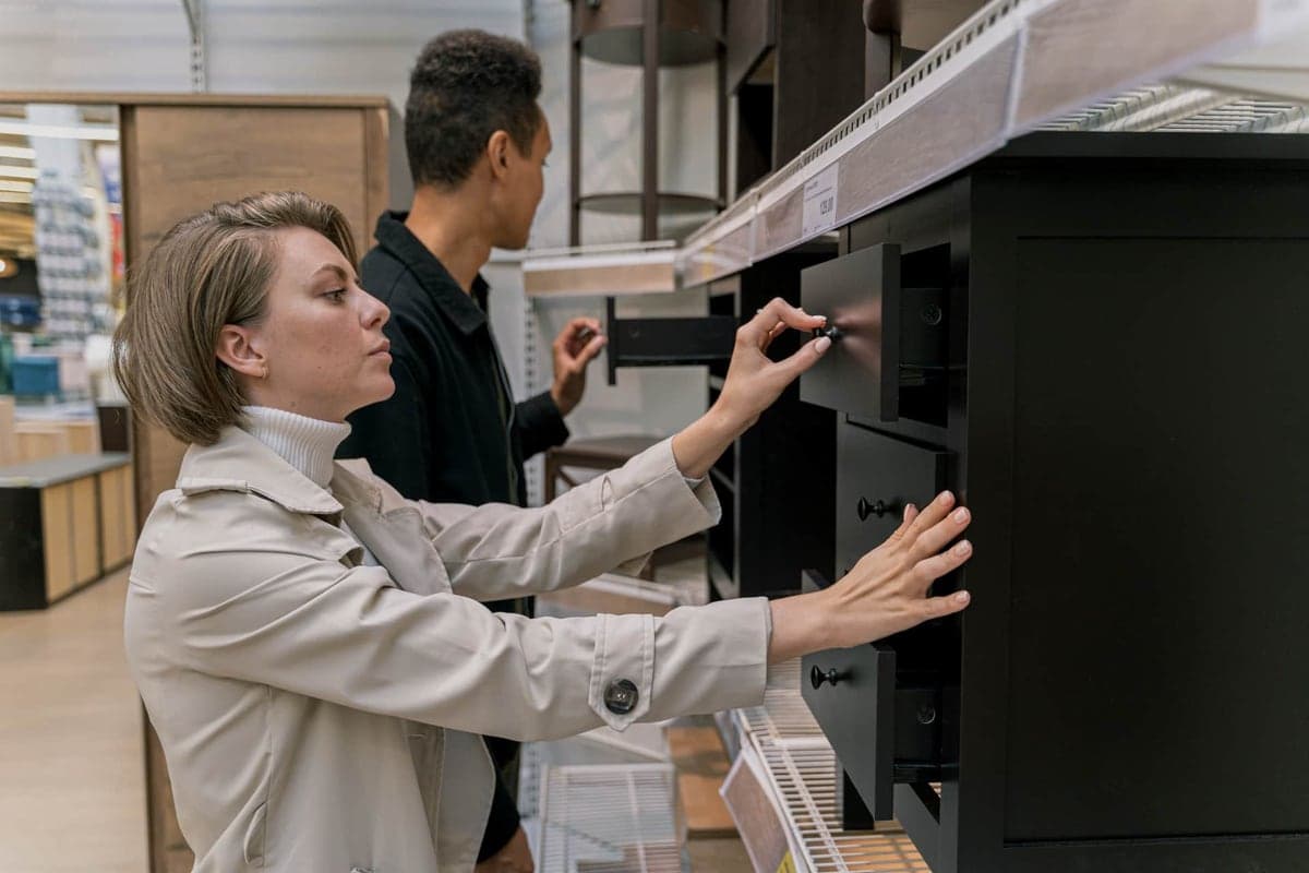 A retail display of garage storage cabinets in a store aisle
