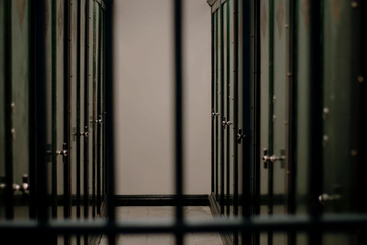 Rows of steel lockers with latch handles in a locker room