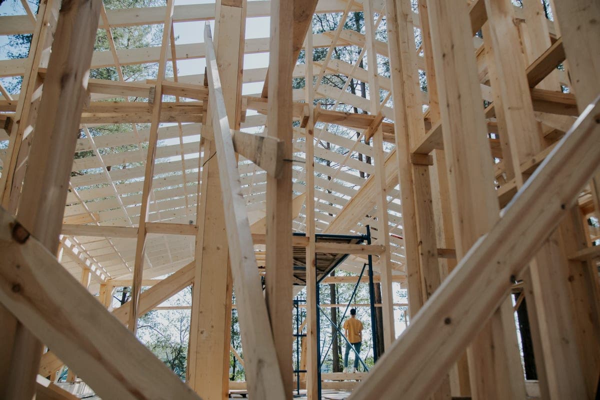 Exposed wooden ceiling joists in an unfinished building
