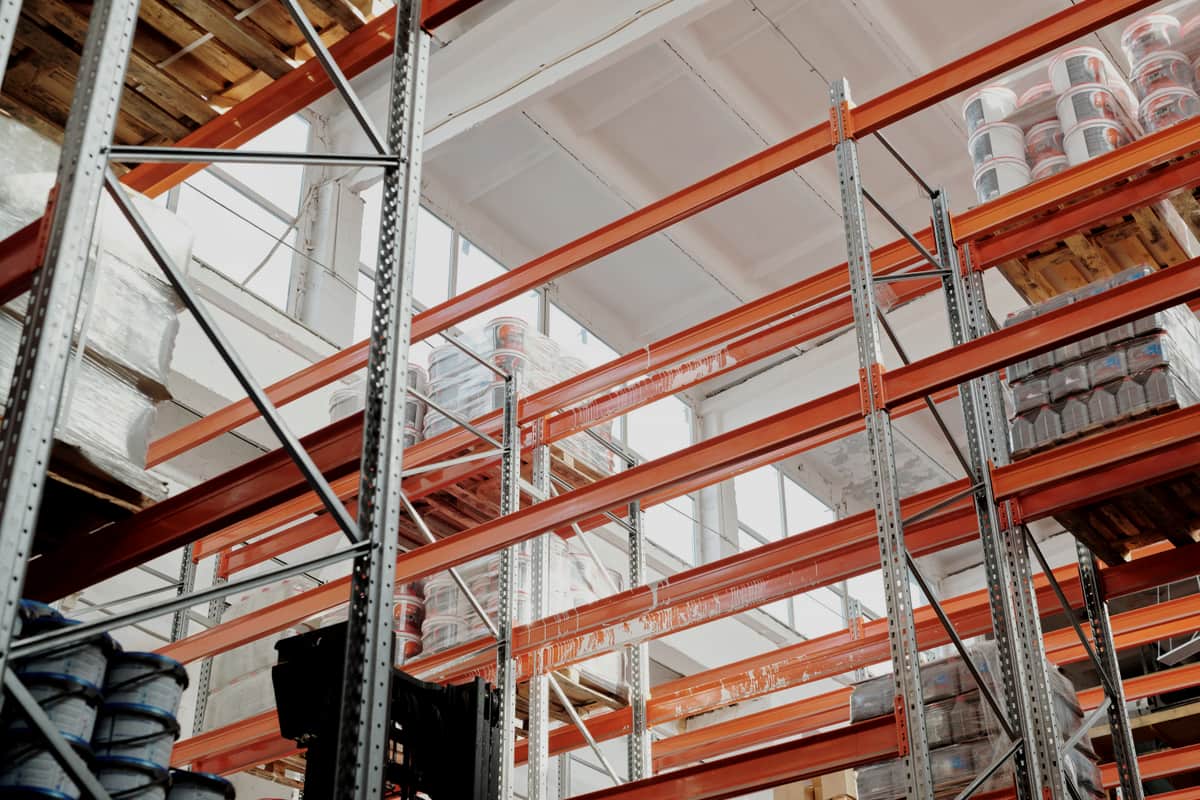 Steel storage racking seen from below against a high ceiling