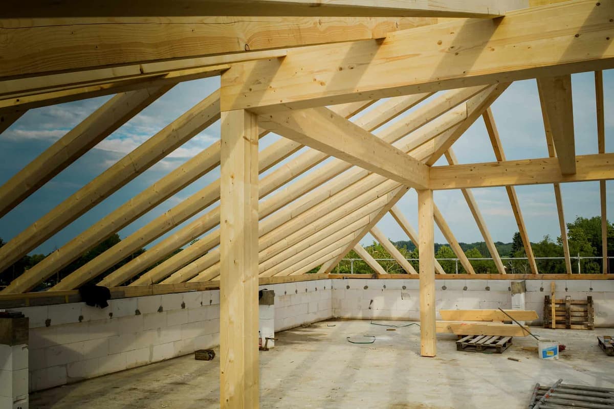 Exposed timber ceiling joists and roof framing above a garage