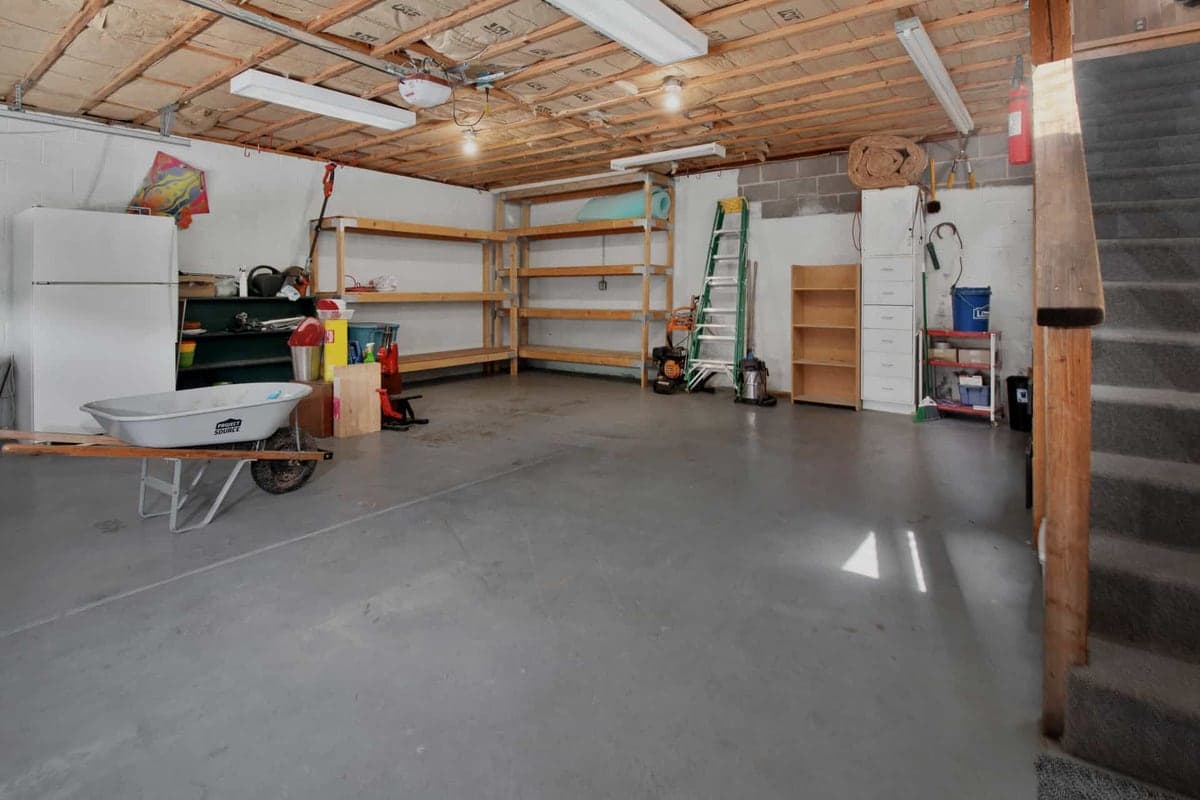 A compact garage interior with limited headroom and storage along one wall