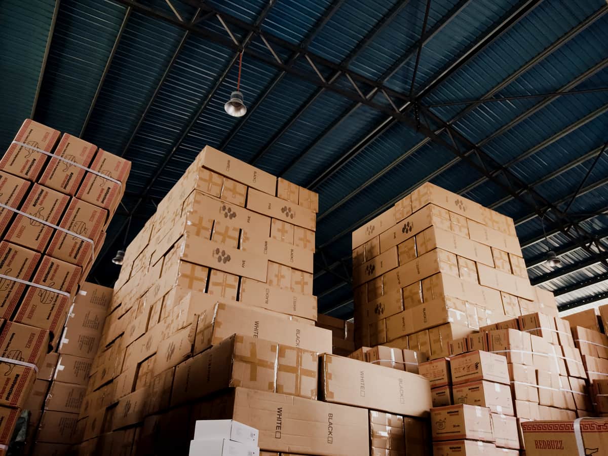 Stacked boxes stored high under a steel roof structure