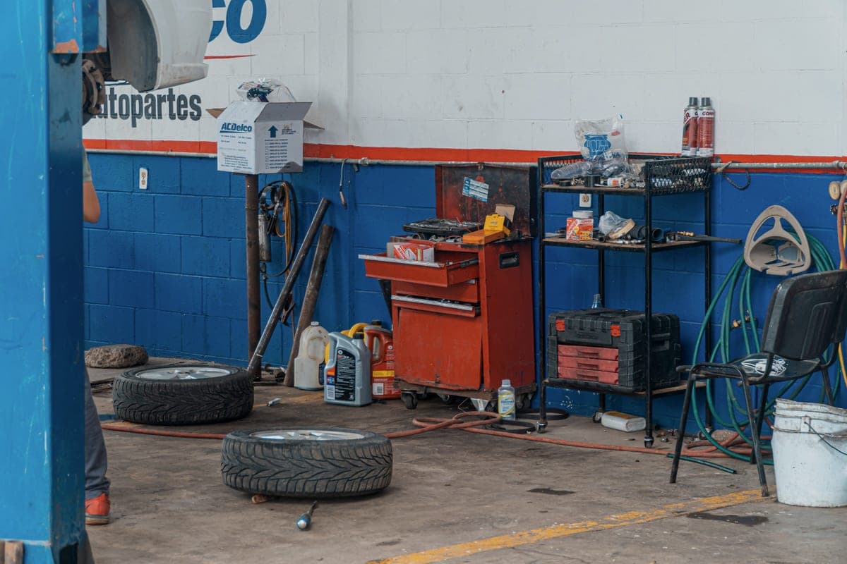 A rolling tool cabinet and wheeled cart in a working garage