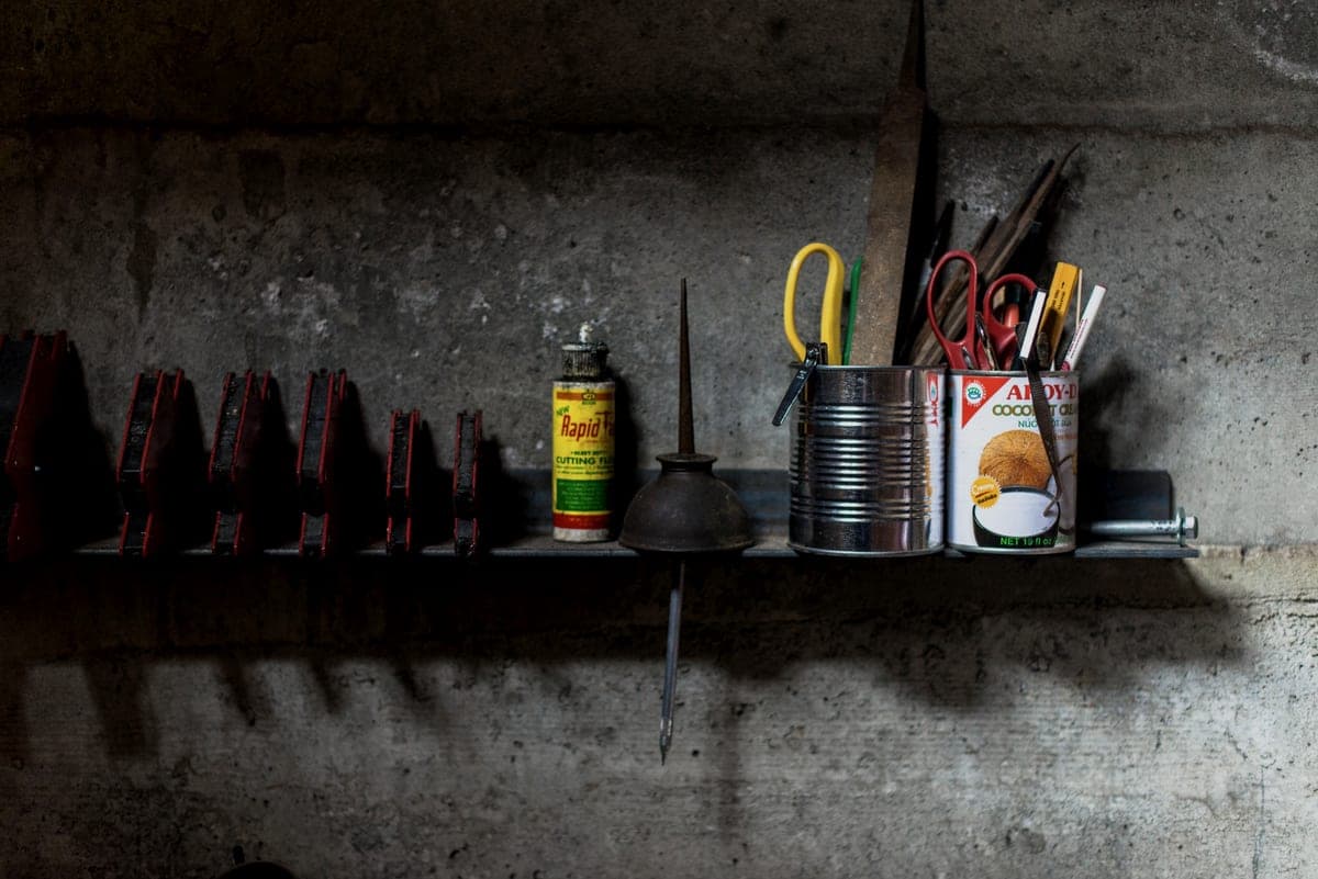 Tools and supplies arranged on a wall-mounted workshop shelf