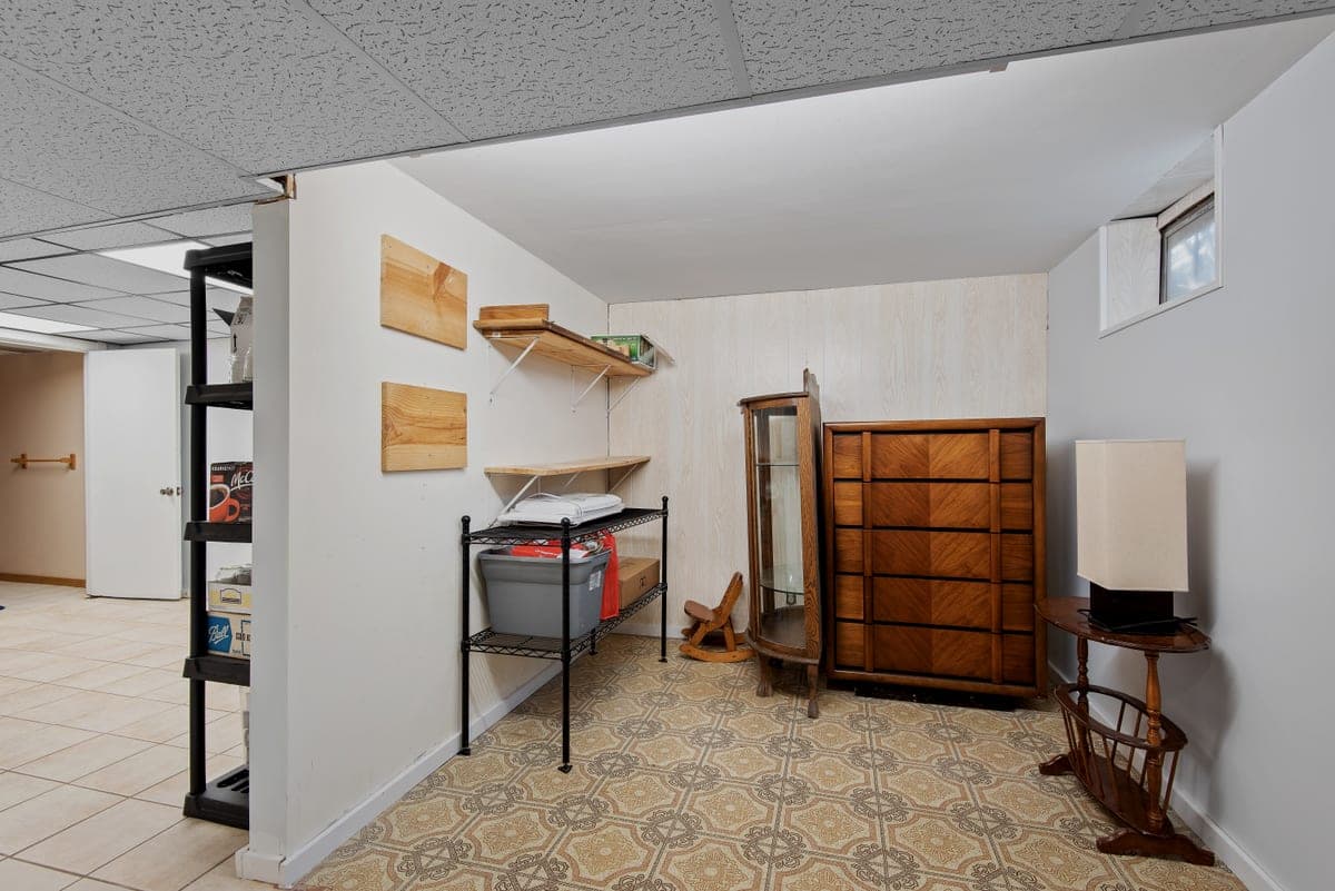 A corner of a storage room fitted with shelving and boxes