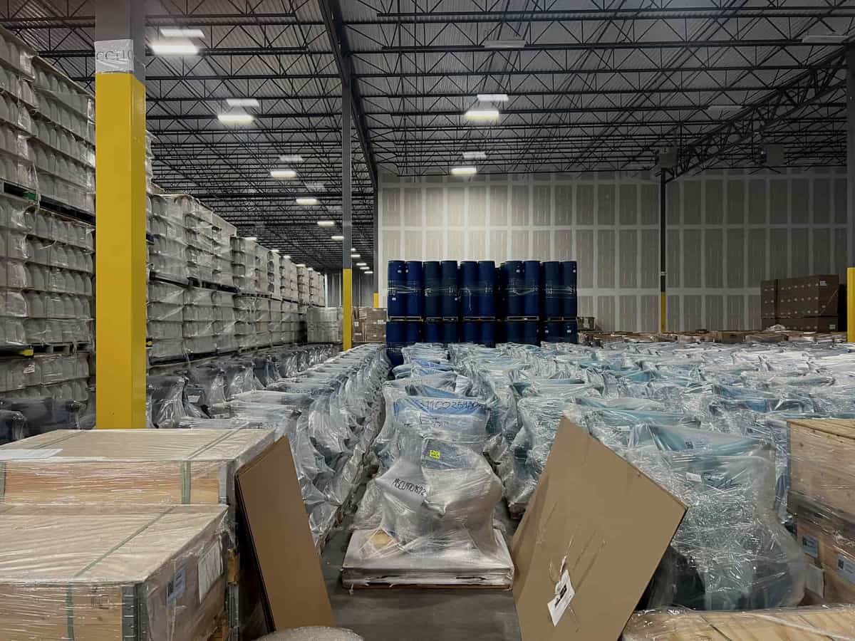 Plastic storage totes stacked on metal shelving in a garage
