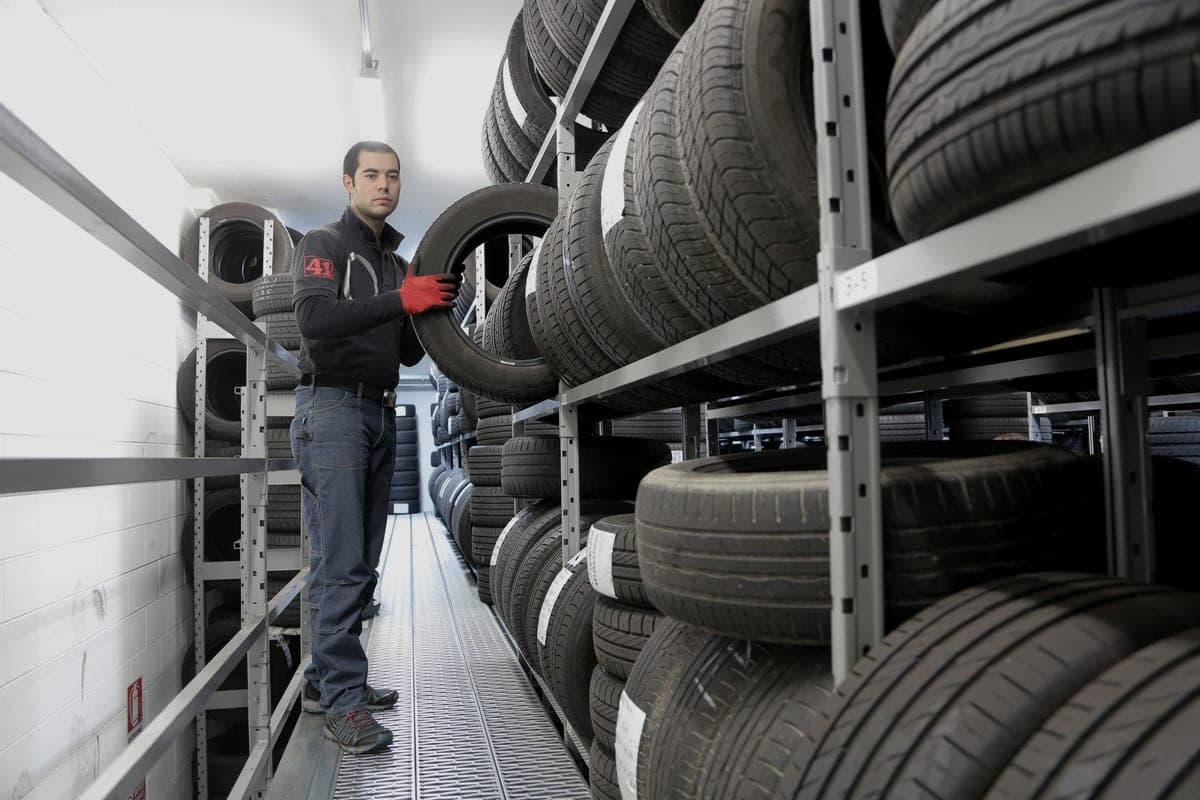 Heavy steel shelving racks loaded with tires in a storage room