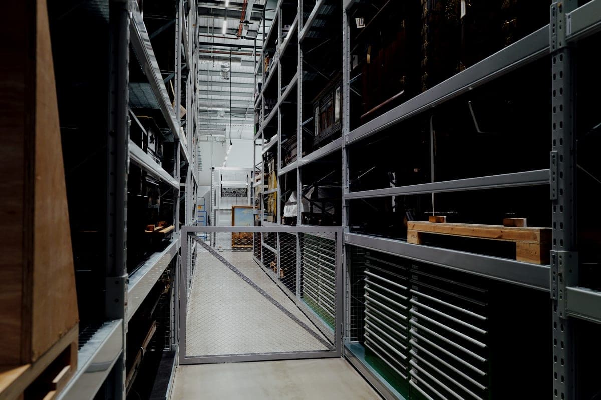 The interior of an industrial storage warehouse lined with metal shelving
