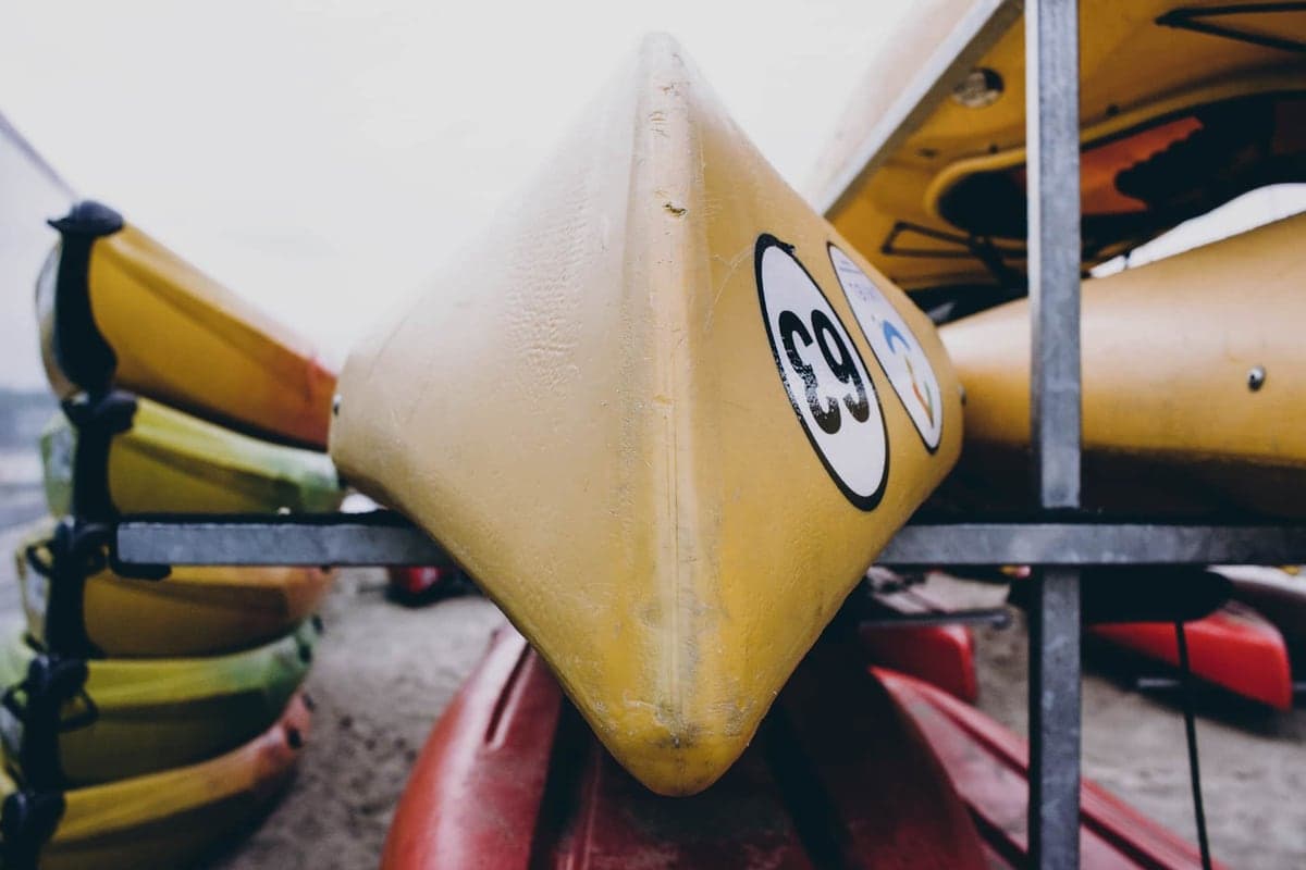 A kayak stored on a rack in a garage