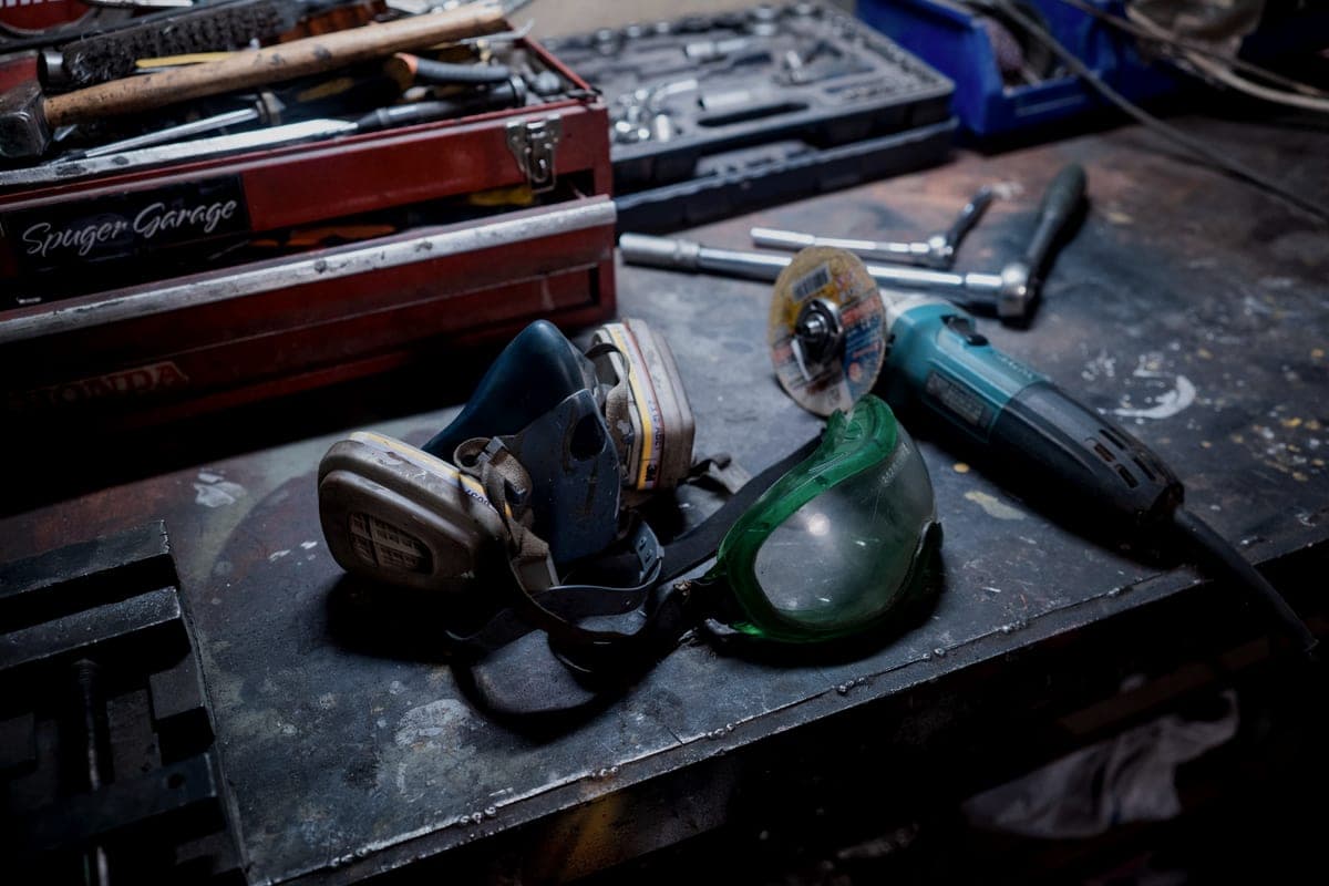 Power tools and cases laid out on a workshop bench