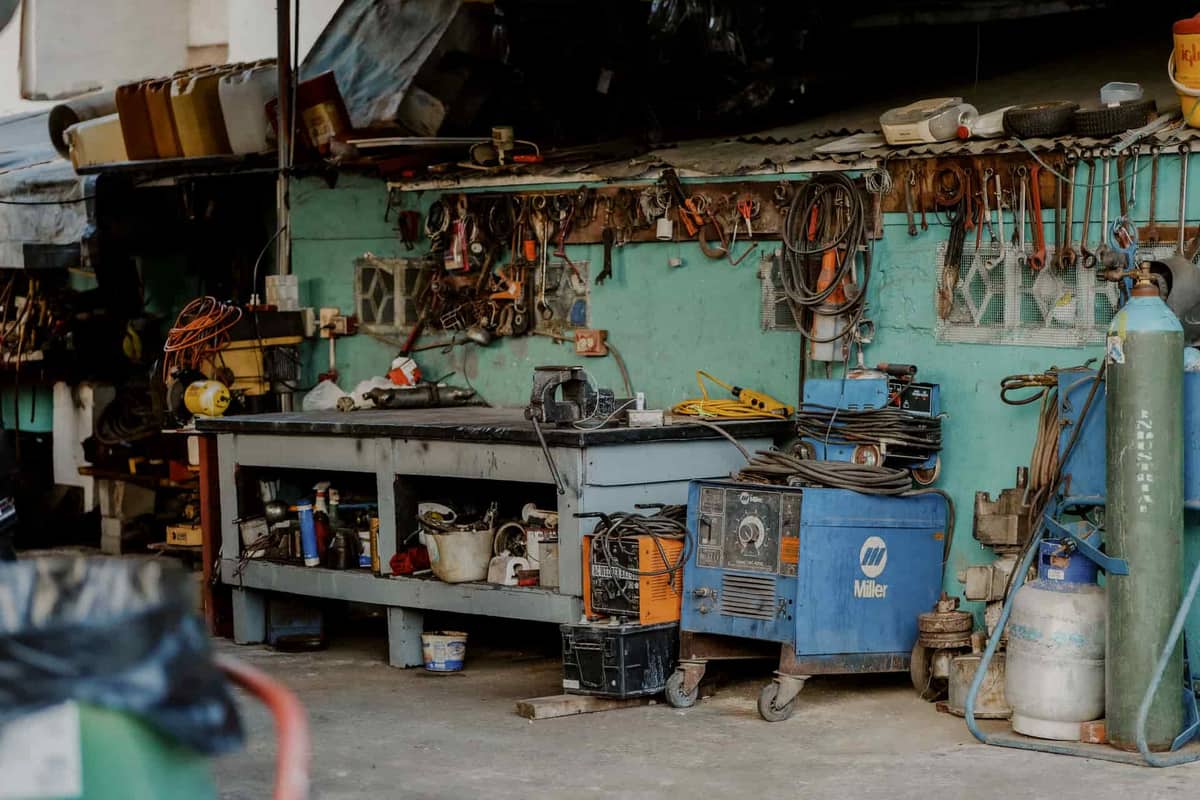 A cluttered garage full of boxes and equipment before organizing